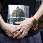 Suze Rotolo, an author, poses with her book in the Greenwich Village section of New York