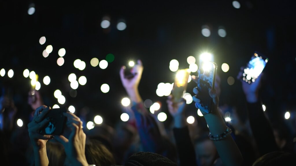 Many,Fun,People,Lift,Hand,Up,Hold,Cell,Phone,Flash